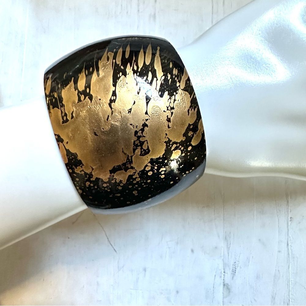 Black and gold tone wide bangle bracelet